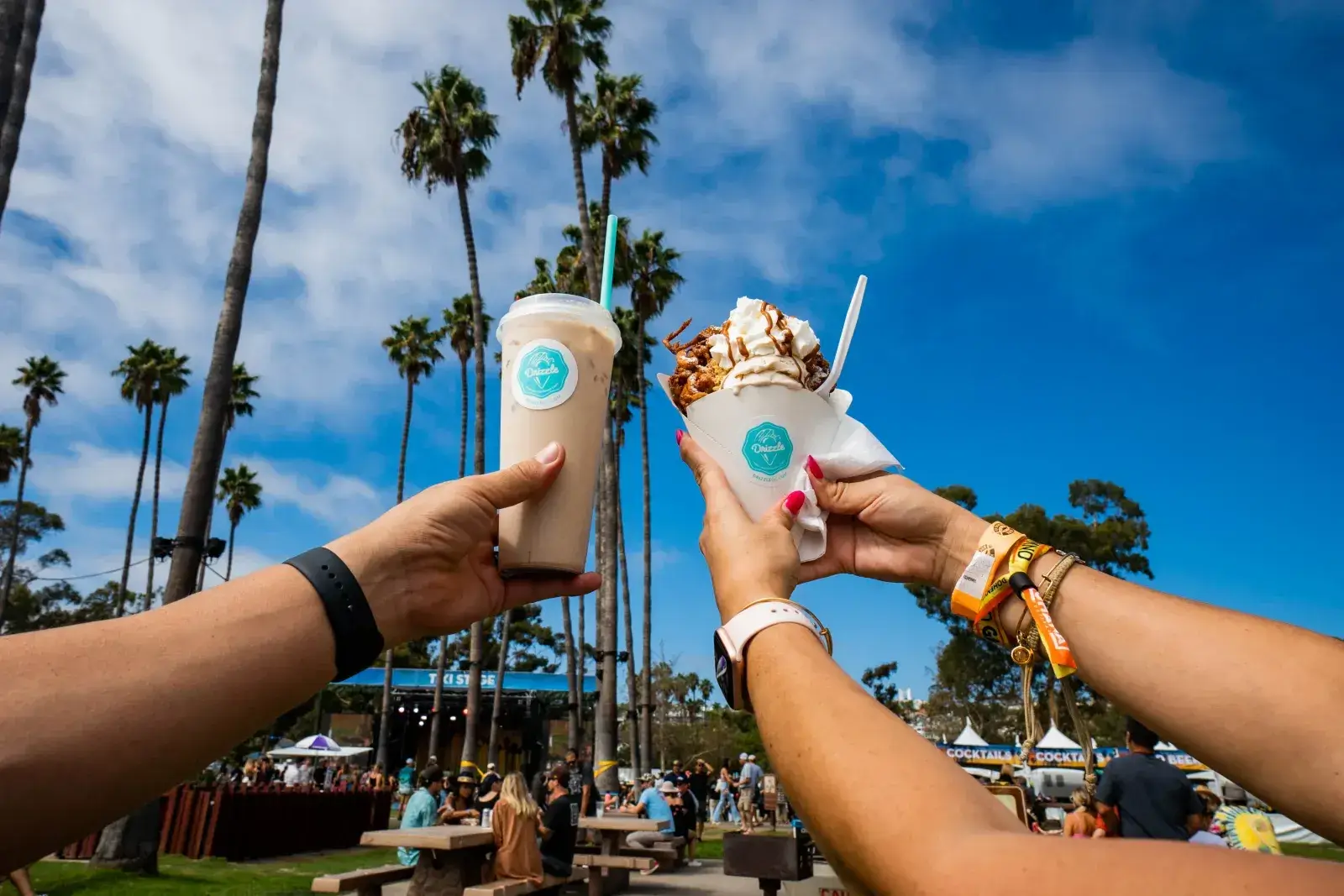 Festivalgoers enjoying drinks and dessert at Ohana Festival's Beachside Bites area