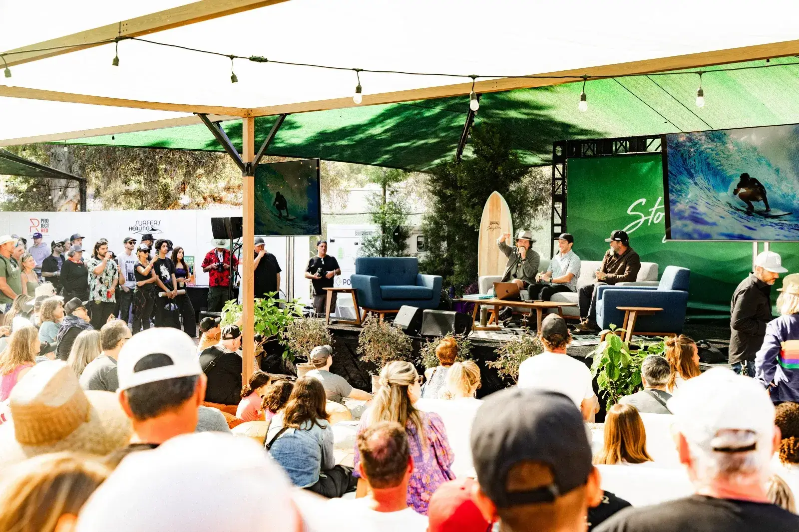 Festivalgoers attending an outdoor storytelling panel in The Cove at Ohana Festival