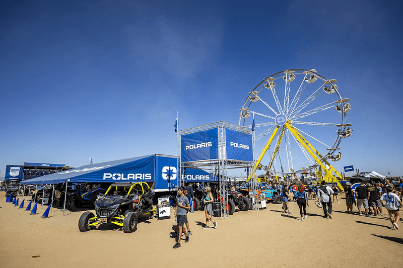 Camp RZR 2023 vendor area with Polaris displays and a Ferris wheel