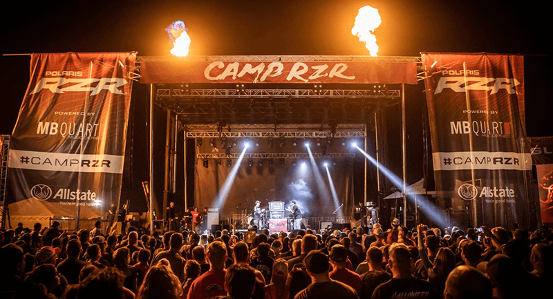Crowd watching an earlier Camp RZR concert beneath stage lights