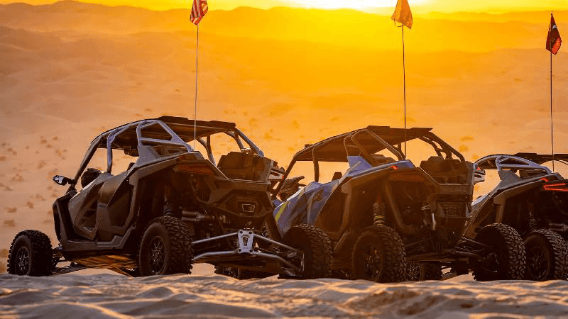 Polaris side-by-sides in golden light at the Glamis dunes