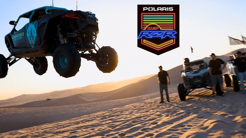 Polaris side-by-side airborne above a sand dune